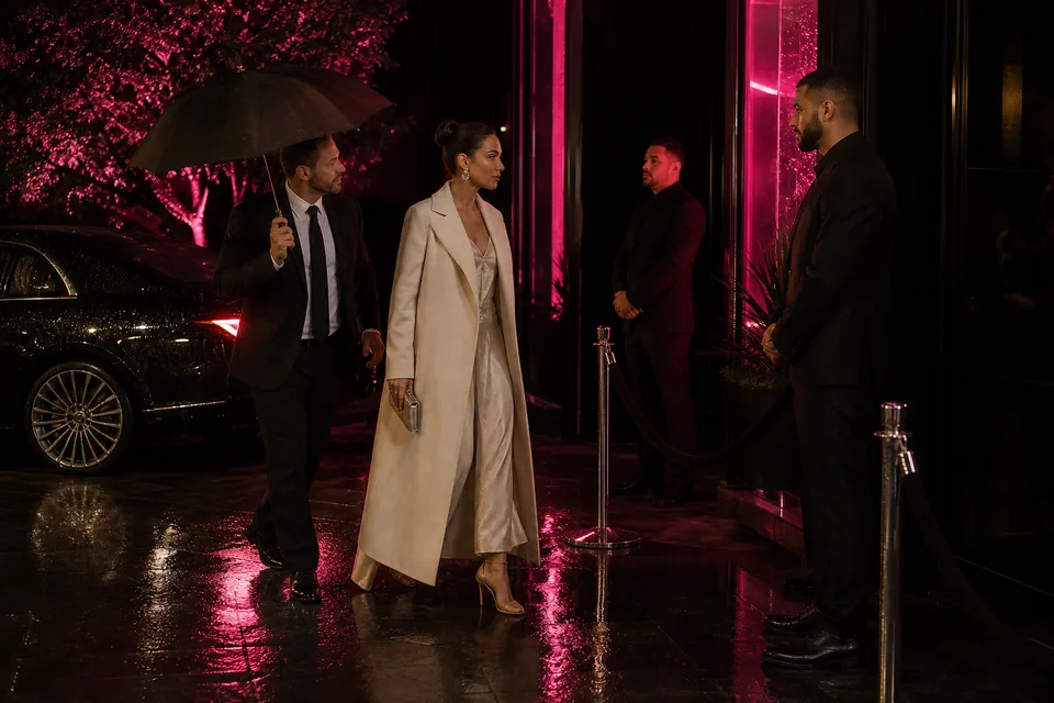 Performer arriving with her manager at a VIP entrance with a velvet rope and security